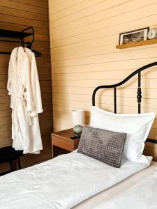 a bedroom with a bed and a towel on a wall at Willow Tiny House - ElysianFields in Sadu +12 photos