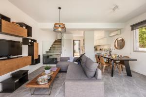 a living room with a couch and a table at Sam's Villa in Paralimni