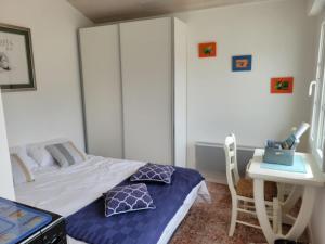 a small bedroom with a bed and a desk at Logis du Pey Roux Accueil Marcheurs Vélos in Saint-Jean-de-Monts