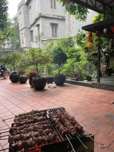 a bunch of food on a grill on a patio at Lee Homestay in Hanoi