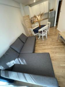 a small room with a bed and a table at Preilos39 in Preila