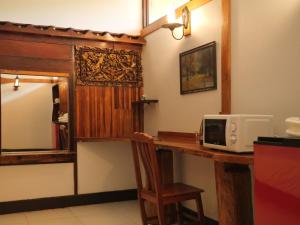 a kitchen with a counter with a microwave on a table at Muangkham in Chiang Rai