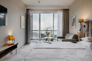 a hotel room with a large bed and a large window at Elements Hotel&Spa in Świeradów-Zdrój