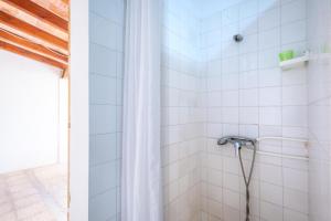 a shower in a white tiled bathroom at Ca Na Clara - Villa Pascual in Port de Pollensa +23 photos