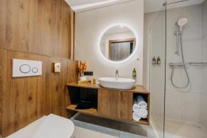a bathroom with a sink and a shower at Elements Hotel&Spa in Świeradów-Zdrój