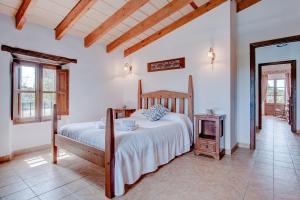 a bedroom with a bed and a table in it at Son Burguet in Llubí +52 photos
