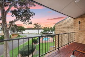 a view from the balcony of a house at Two bedroom river view unit with pool in Maroochydore