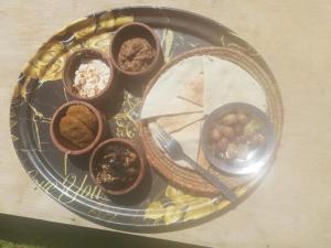 a glass plate with bowls of food on a table at M Biama Island in Siwa