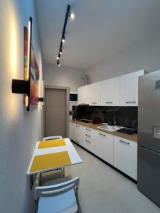 a kitchen with a yellow table and white cabinets at Selena Boutique in Neos Marmaras +3 photos