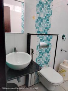 a bathroom with a sink and a toilet at Townhouse Nisarga in Chikmagalūr