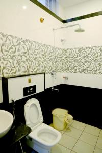 a bathroom with a toilet and a sink at Townhouse Nisarga in Chikmagalūr