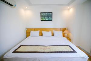 Giường trong phòng chung tại Nhat Linh Hotel & Suites Da Nang