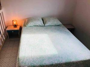 a bedroom with a large bed with two night stands at La maison aux galets in Talmont
