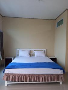 Кровать или кровати в номере La Lanoe Homes Ranau