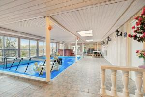 a swimming pool in the middle of a house at Pool House With Space For Relaxation in Bording Stationsby