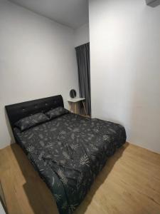 a bed with a black comforter in a bedroom at Serene Stay at Kuching City in Kuching +17 photos