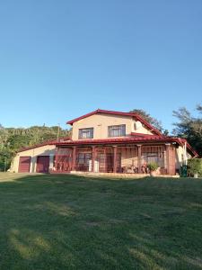 a house with a green field in front of it at Marinda's in Hibberdene