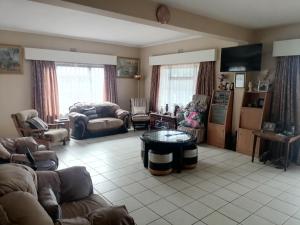 a living room with a couch and a table in it at Marinda's in Hibberdene