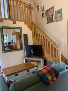 a living room with a couch and a television at Idyllic Gite Holidays In Rural Stunning French Countryside With Pool in Antigny