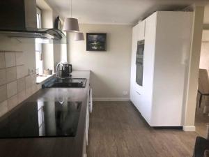 a kitchen with a sink and a counter top at Family House Near Beach With Garden in Sarup