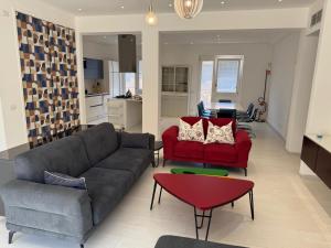 a living room with two couches and a red table at Casa vacanza Tolda in Lido di Ostia +7 photos