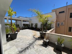 a courtyard with potted plants and a building at Casa vacanza Tolda in Lido di Ostia