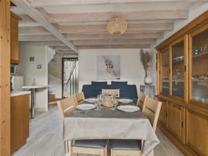 a dining room with a table and chairs at 400m de la plage, jardin, maison pour 5 in Kermoisan