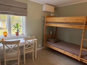 a bedroom with a bunk bed and a desk at Mjölby Vandrarhem in Mjölby