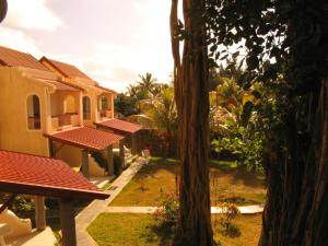a view of a yard with houses and a tree at Villas Banyan in Grand Gaube