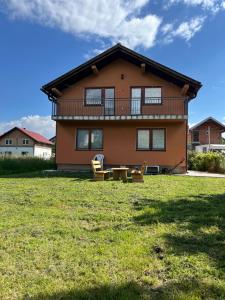 a large house with a lawn in front of it at Butmir house-Sarajevo in Sarajevo