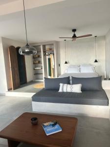 a bedroom with a large bed with a wooden table at Appartement vue mer Vulpaghja 01 in Cargèse