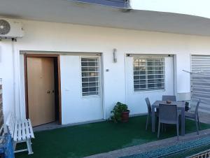 a patio with a table and chairs next to a house at Deliziosa House - Schiavonea in Schiavonea