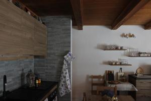 a kitchen with a counter and a table in it at B&B La Meridiana Moncenisio in Moncenisio +26 photos