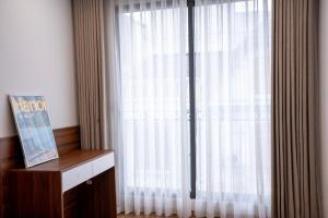 a room with a large window with white curtains at Hanoi Nest Seekers -New Branding - WestLake view Building in Hanoi