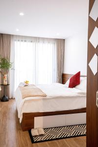 a bedroom with a large bed and a window at Hanoi Nest Seekers -New Branding - WestLake view Building in Hanoi