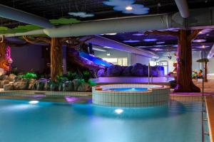 a indoor water park with a water slide at Vakantiepark BreeBronne in Maasbree +18 photos