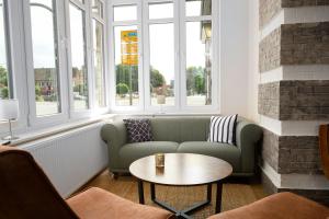 a living room with a couch and a table at Ferienwohnung im Hotel Preyt 35228 in Holtlander Nücke