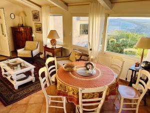 a dining room with a table and chairs and a window at Sete La Vigie Singuliere in Sète +12 photos