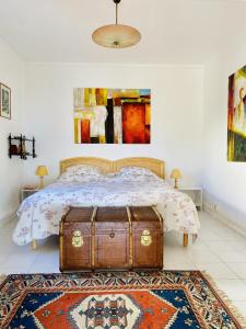 a bedroom with a bed with a trunk on it at Sete La Vigie Singuliere in Sète