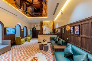 a living room with a couch and a table at RosaLie Quảng Bình Hotel in Dong Hoi