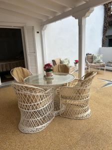 a glass table and chairs on a patio at Schönes Apartment - ruhig - Aussenpool in La Orotava