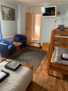 a bedroom with a bunk bed and a living room at Penzion Sport in Gaming