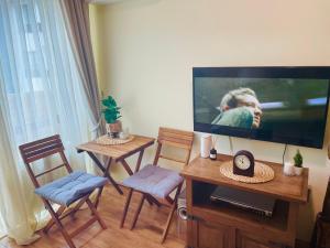 a living room with a flat screen tv on a wall at Apartment in Bansko, very close to the Gondola in Bansko +13 photos