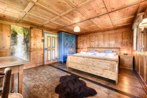 a bedroom with a bed in a wooden room at Chalet Zimbablick in Bartholomäberg +28 photos