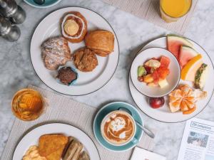 four plates of breakfast food on a table at 25hours Hotel Dubai One Central in Dubai