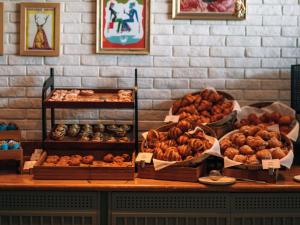 a bakery with various types of pastries on a counter at 25hours Hotel Dubai One Central in Dubai