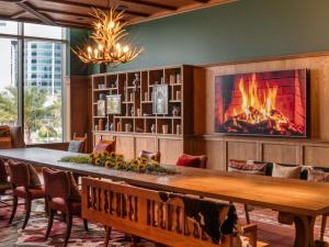a dining room with a fireplace and a table and chairs at 25hours Hotel Dubai One Central in Dubai