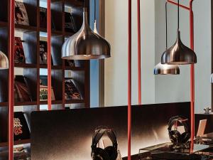 a room with three pendant lights and a table with shoes at 25hours Hotel Dubai One Central in Dubai
