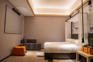 Llit o llits en una habitació de Arthur Hotel Zhujiang New Town Guangzhou-Pazhou Exhibition Center Branch