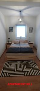 a bedroom with a large bed and a window at PrzyLądek 30 in Lądek-Zdrój